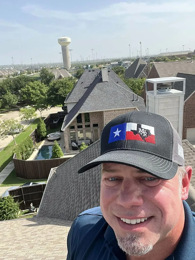 Robert McAdams on a roof above a North Texas neighborhood